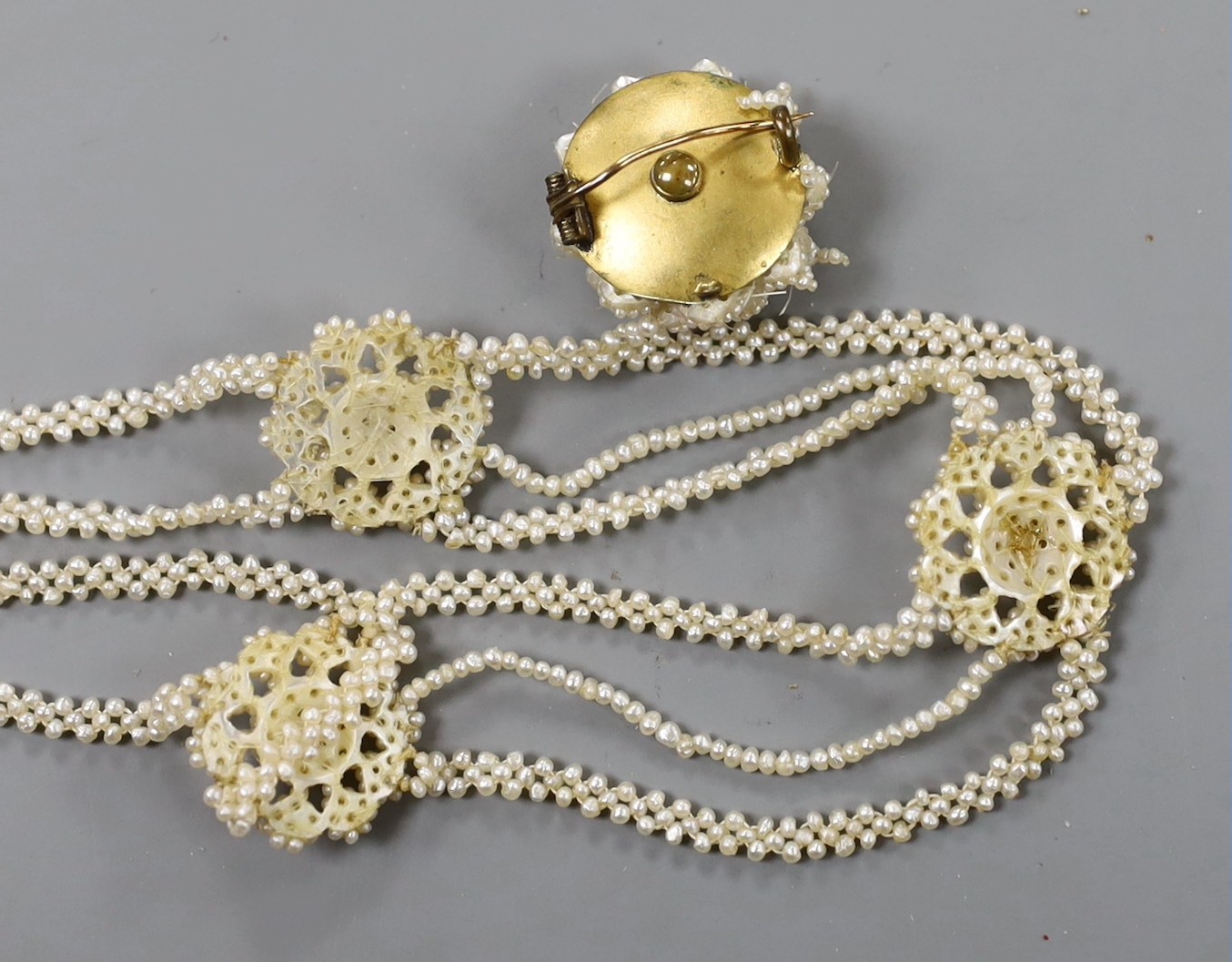 A 19th century seed pearl cluster set necklace, with yellow metal clasp, 32cm and a similar brooch.